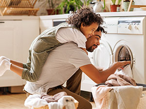 Father and son doing laundry together.